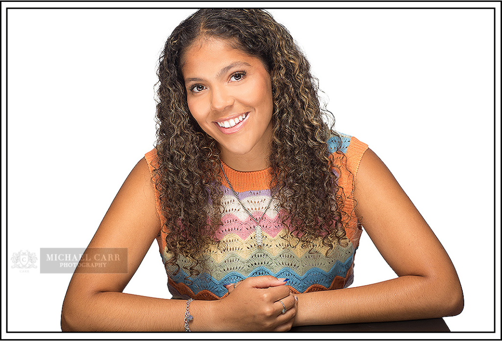 Professional Photographer Houston Professional Houston senior portrait of a smiling high school student in a colorful top