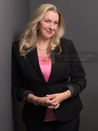 Professional Photographer Houston Executive business portrait of a professional woman photographed on a studio background in Houston.