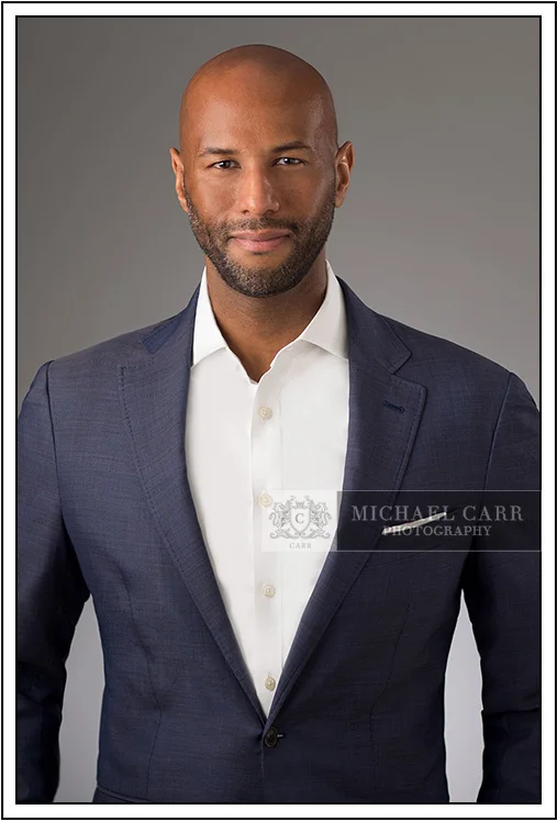 Professional Photographer Houston Houston modern casual headshot of a business professional wearing a blue blazer and open-collar white shirt