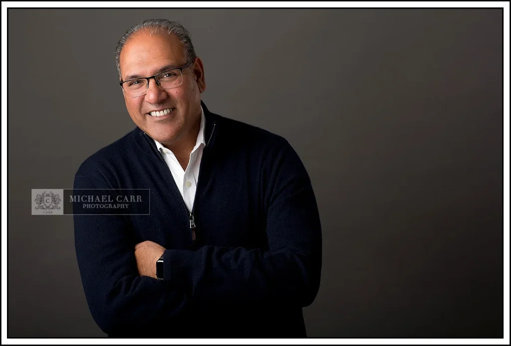 Professional Photographer Houston Houston modern casual headshot of a business professional wearing a navy quarter-zip sweater over a white dress shirt