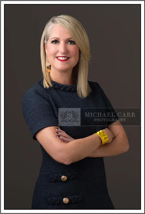 Professional Photographer Houston Houston modern casual headshot of a business professional wearing a navy textured dress with folded arms