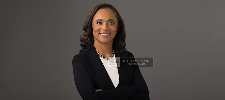 Professional Photographer Houston Professional headshot of a businesswoman against a gray background during a Houston personal branding photography session.