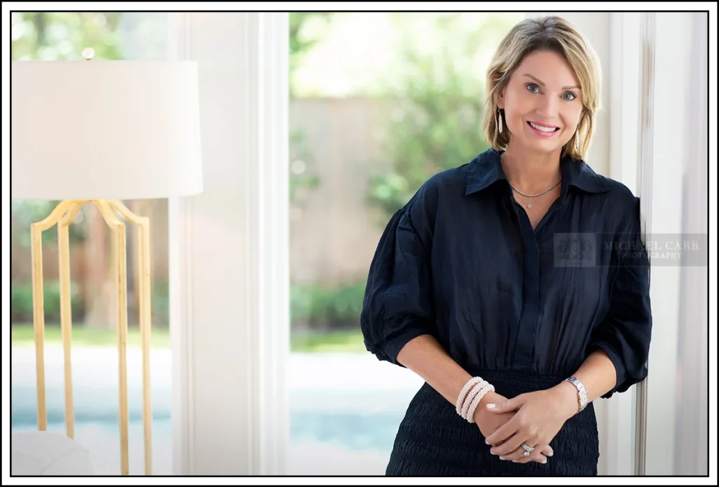 Professional Photographer Houston Personal branding portrait of a professional woman photographed with natural light in a modern studio setting.