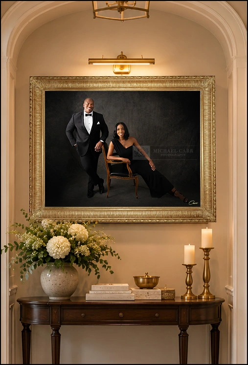 Framed fine art portrait displayed above a console table in a traditional hallway