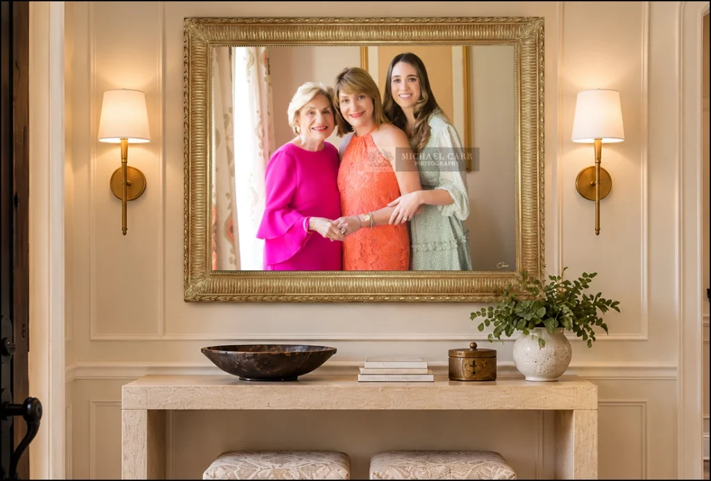 Framed portrait of three generations of women displayed above a console table
